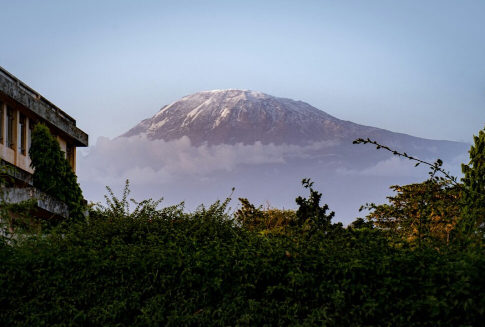 Best time to climb Kilimanjaro – snow-covered Mount Kilimanjaro seen from the town below
